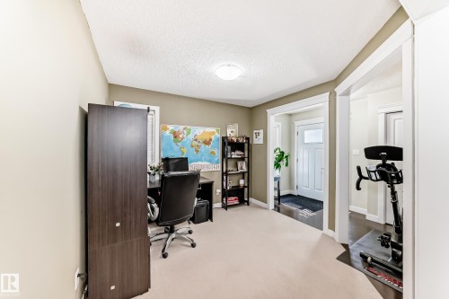 Well-lit interior space featuring neutral wall tones, white trim, and carpeted flooring - 3433 Goodridge Link Link, Edmonton, AB - Indoor