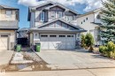 The property features a two-story exterior with light-colored siding and stone accents - 3433 Goodridge Link Link, Edmonton, AB  - Outdoor With Facade 