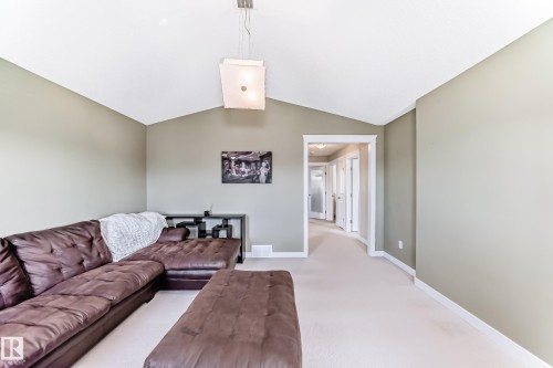 This property features a spacious room with a vaulted ceiling and light-colored carpeting - 3433 Goodridge Link Link, Edmonton, AB - Indoor Photo Showing Other Room