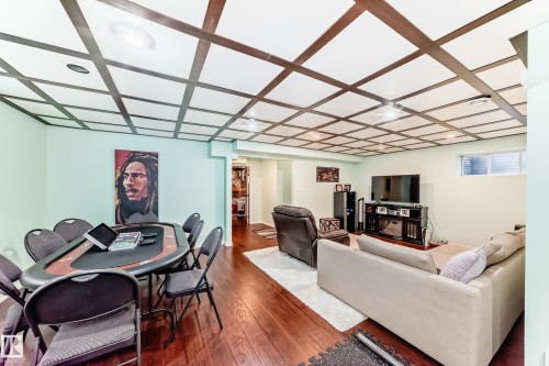The interior features hardwood flooring, a coffered ceiling with recessed lighting, and light-colored walls - 3433 Goodridge Link Link, Edmonton, AB - Indoor