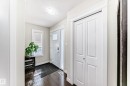 Welcoming entry with hardwood floors and a white paneled door with window accents - 3433 Goodridge Link Link, Edmonton, AB  - Indoor Photo Showing Other Room 