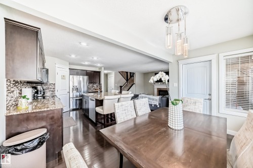 The property features an open-concept living area with dark hardwood floors throughout - 3433 Goodridge Link Link, Edmonton, AB - Indoor