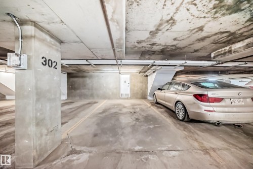 Assigned parking space in the underground garage, featuring concrete flooring and numbered column - 44 13825 155 Avenue, Edmonton, AB - Indoor Photo Showing Garage