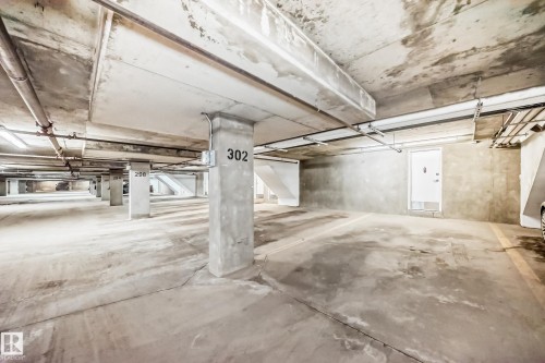 Underground parking space with concrete flooring and exposed piping - 44 13825 155 Avenue, Edmonton, AB - Indoor Photo Showing Garage