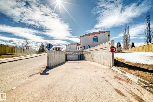 The property features a private underground parking entrance with an automatic barrier - 44 13825 155 Avenue, Edmonton, AB - Outdoor