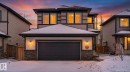 The property features a two-story design with a prominent garage and stone accents on the facade - 13 Spring Link, Spruce Grove, AB  - Outdoor 