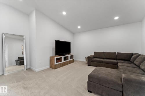 Living area featuring light-colored carpeting, white walls, and recessed lighting - 13 Spring Link, Spruce Grove, AB - Indoor
