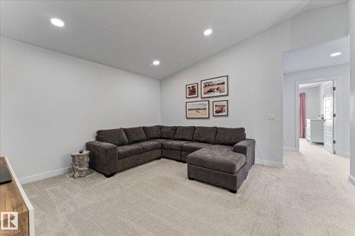 This versatile space features light-colored carpeting, recessed lighting, and a neutral wall color, providing a bright and inviting atmosphere - 13 Spring Link, Spruce Grove, AB - Indoor