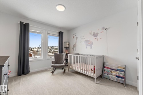 This room features plush grey carpeting and white walls, creating a bright and neutral aesthetic - 13 Spring Link, Spruce Grove, AB - Indoor Photo Showing Bedroom