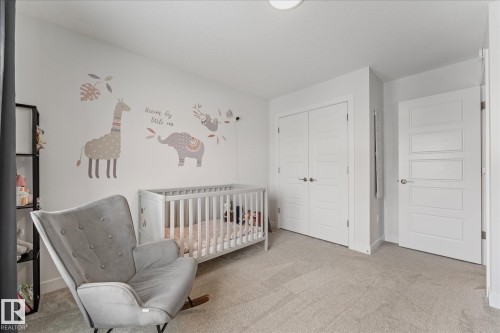 This room features light-colored carpeting, white walls, and bright white doors - 13 Spring Link, Spruce Grove, AB - Indoor Photo Showing Bedroom