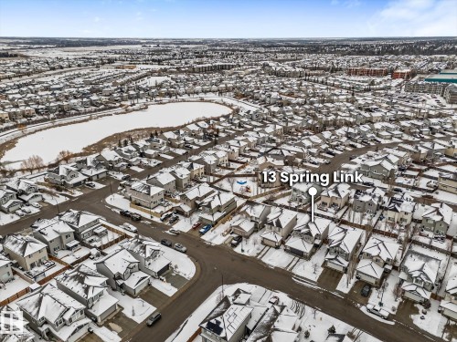 Aerial view of the property and its surrounding neighborhood, showcasing a nearby body of water - 13 Spring Link, Spruce Grove, AB - Outdoor With View