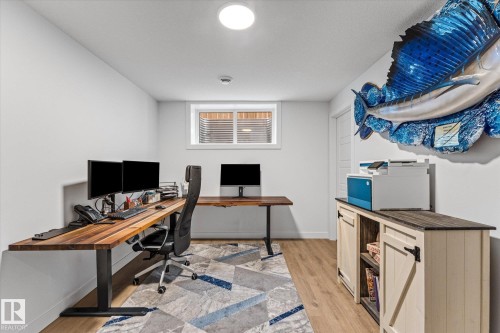 Office space featuring light wood-style flooring, a window with blinds, and white walls - 13 Spring Link, Spruce Grove, AB - Indoor Photo Showing Office