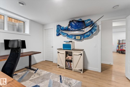 This versatile room features light-toned flooring and white walls, offering a bright and adaptable space - 13 Spring Link, Spruce Grove, AB - Indoor Photo Showing Office