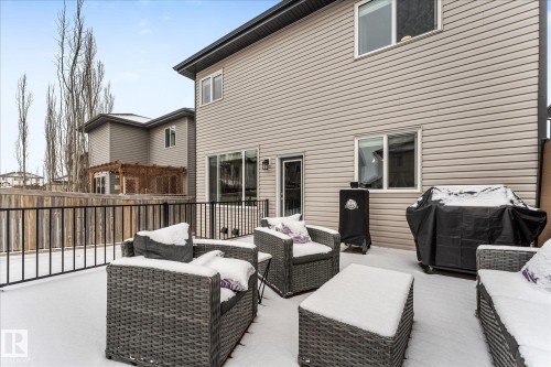 The property features a spacious deck with dark-colored railings, offering an inviting outdoor area - 13 Spring Link, Spruce Grove, AB - Outdoor With Deck Patio Veranda With Exterior