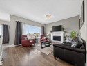1047 Coopers Hawk Link Link, Edmonton, AB  - Indoor Photo Showing Living Room With Fireplace 