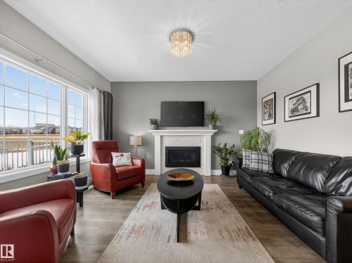 1047 Coopers Hawk Link Link, Edmonton, AB - Indoor Photo Showing Living Room With Fireplace