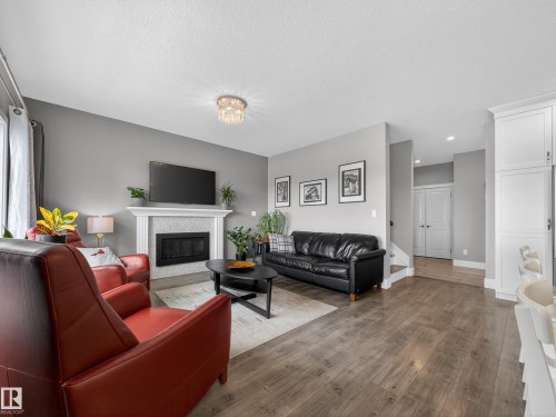 1047 Coopers Hawk Link Link, Edmonton, AB - Indoor Photo Showing Living Room With Fireplace