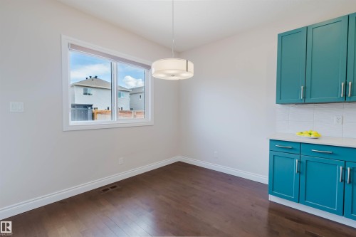 This bright space features a window, recessed lighting, and rich wood flooring - 4875 Wright Drive, Edmonton, AB - Indoor Photo Showing Other Room