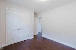 This room features dark hardwood flooring, white baseboards, and light-colored walls - 