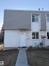 The property features a two-story exterior with a combination of textured stucco and horizontal siding, a white front door with an arched window, and a concrete pathway leading to the entrance - 124 Cornell Court, Edmonton, AB  - Outdoor 