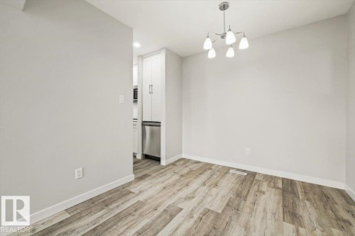 This room features light-toned walls and wood-look flooring - 12C Castle Terrace, Edmonton, AB - Indoor Photo Showing Other Room