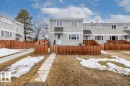 The property features a private fenced yard, a light-colored siding exterior, and multiple windows - 12C Castle Terrace, Edmonton, AB  - Outdoor 