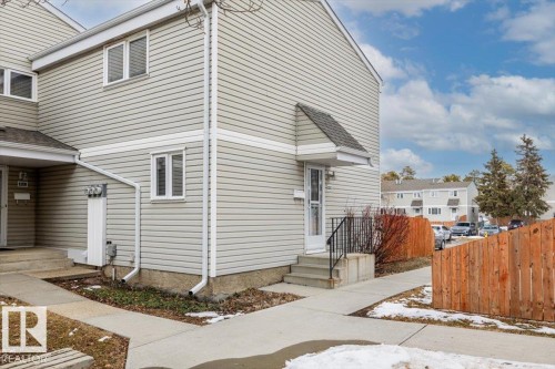 The property features light-colored horizontal siding, white trim, and a gabled roofline - 12C Castle Terrace, Edmonton, AB - Outdoor