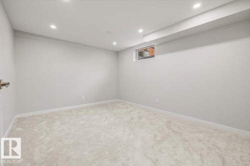 Spacious room with light-colored carpet, recessed lighting, and a window - 12C Castle Terrace, Edmonton, AB - Indoor