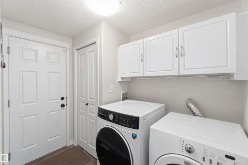 Dedicated laundry area featuring white cabinetry and light-colored walls - 31 Everitt Drive, St. Albert, AB - Indoor Photo Showing Laundry Room