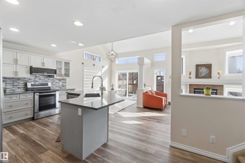 The kitchen features light-colored cabinetry, a gray tiled backsplash, and stainless steel appliances - 31 Everitt Drive, St. Albert, AB - Indoor Photo Showing Kitchen With Upgraded Kitchen
