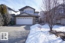 The property features a two-car garage, a concrete driveway, and a stone facade on the lower level - 31 Everitt Drive, St. Albert, AB  - Outdoor With Facade 