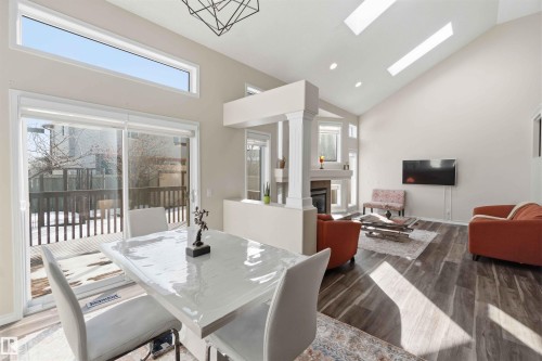 The property features an open living space with vaulted ceilings, skylights, and large windows providing ample natural light - 31 Everitt Drive, St. Albert, AB - Indoor