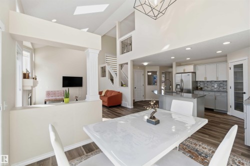 The property features an open-concept living area with high ceilings, skylights, and hardwood style flooring - 31 Everitt Drive, St. Albert, AB - Indoor Photo Showing Dining Room