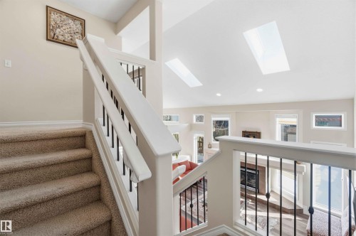 The property features an interior staircase with carpeted treads and a white banister with black spindles - 31 Everitt Drive, St. Albert, AB - Indoor Photo Showing Other Room