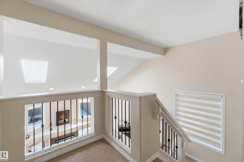 The property features a staircase with decorative metal balusters and a carpeted landing - 31 Everitt Drive, St. Albert, AB - Indoor Photo Showing Other Room