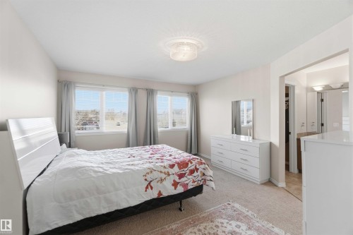 This bedroom features carpeted flooring, three windows with blinds, and light-colored walls - 31 Everitt Drive, St. Albert, AB - Indoor Photo Showing Bedroom