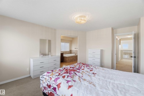 This bedroom features neutral-toned walls and carpeted flooring, creating a soothing atmosphere - 31 Everitt Drive, St. Albert, AB - Indoor Photo Showing Bedroom