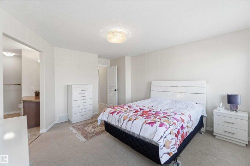 This bright bedroom features light-colored walls and carpeted flooring - 31 Everitt Drive, St. Albert, AB - Indoor Photo Showing Bedroom