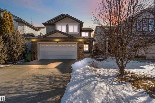 The property features a two-story exterior with a stone accent facade and a two-car garage - 31 Everitt Drive, St. Albert, AB - Outdoor