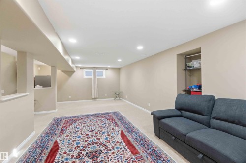 This expansive room features light-colored carpeting, recessed lighting, and a window with drapes - 31 Everitt Drive, St. Albert, AB - Indoor