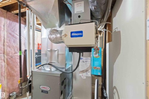 The property includes a Lennox furnace and a humidification system, visible alongside ductwork and various utility lines - 31 Everitt Drive, St. Albert, AB - Indoor Photo Showing Basement