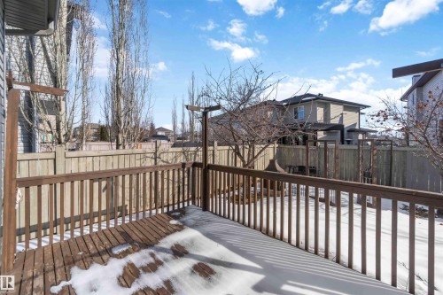 The property features a wooden deck with a railing and a view of the fenced yard - 31 Everitt Drive, St. Albert, AB - Outdoor With Deck Patio Veranda With Exterior