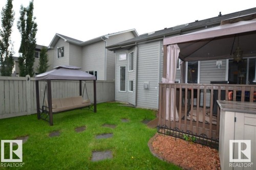 The property features a fenced backyard with a lawn and stone stepping pads - 31 Everitt Drive, St. Albert, AB - Outdoor