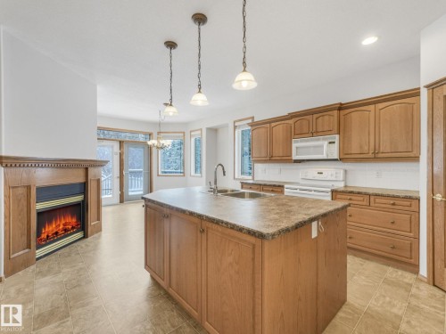 3436 32 Street, Edmonton, AB - Indoor Photo Showing Kitchen With Fireplace With Double Sink