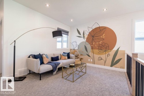 This versatile living area features carpeted flooring, recessed lighting, and a window providing natural light - 102 Bluff Cove, Leduc, AB - Indoor
