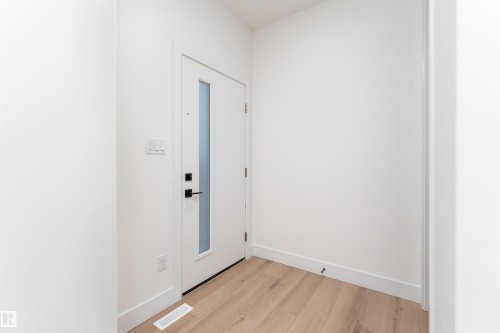 Entryway with light wood finished floors and baseboards - 3109 Magpie Way, Edmonton, AB 