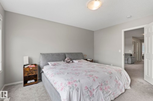 Bedroom featuring light gray walls, light gray carpet flooring, and a ceiling-mounted light fixture - 5164 Lark Crescent Nw, Edmonton, AB - Indoor Photo Showing Bedroom