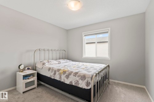Bedroom with light grey walls, a single window, and grey carpet flooring - 5164 Lark Crescent Nw, Edmonton, AB - Indoor Photo Showing Bedroom