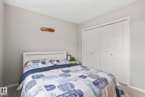 This room features light grey walls and grey carpet flooring - 5164 Lark Crescent Nw, Edmonton, AB - Indoor Photo Showing Bedroom