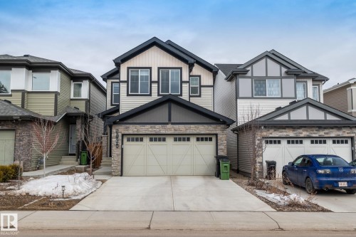 The property features a two-story design with a light-colored siding facade and dark trim accents - 5164 Lark Crescent Nw, Edmonton, AB - Outdoor With Facade